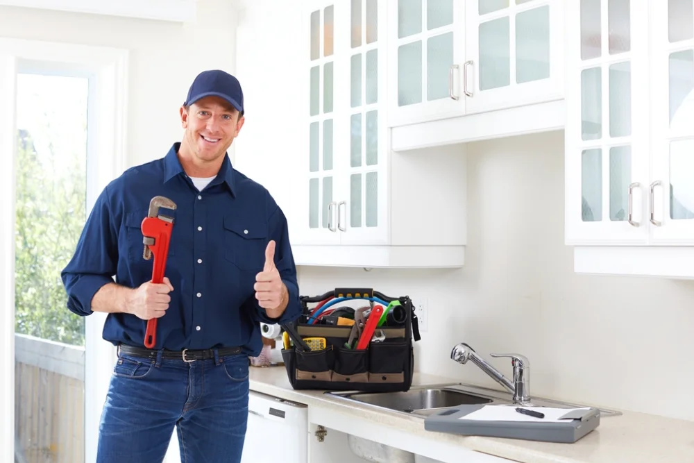 plumber in the kitchen with his tools avoiding plumbing mistake